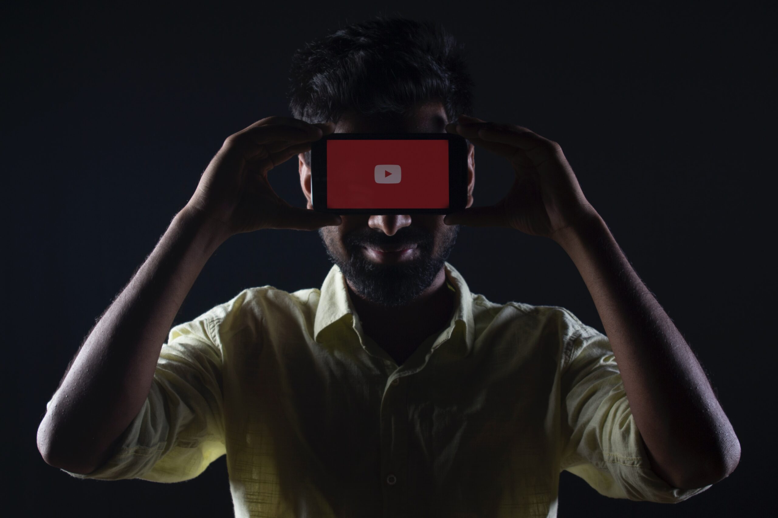man watching youtube on phone